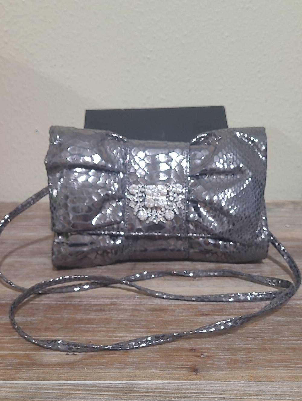 IMAN Metallic Silver Textured Crossbody Clutch with Crystal Brooch